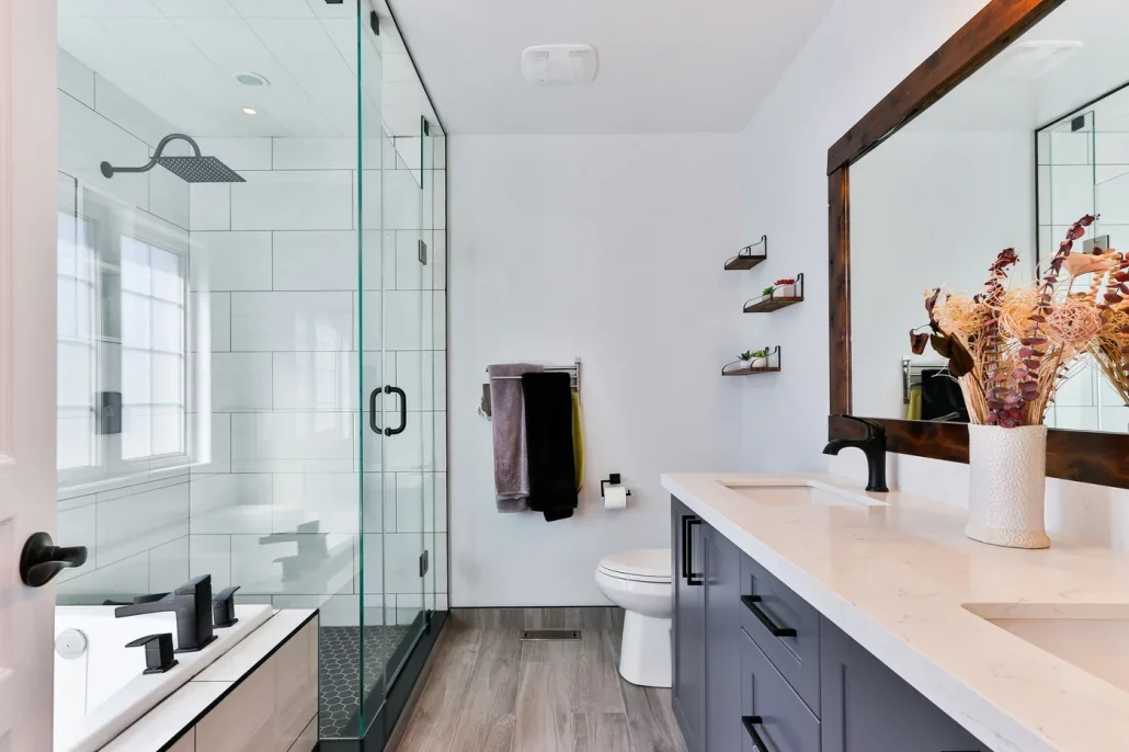 Finished bathroom with glass shower, vanity and tiled wet area