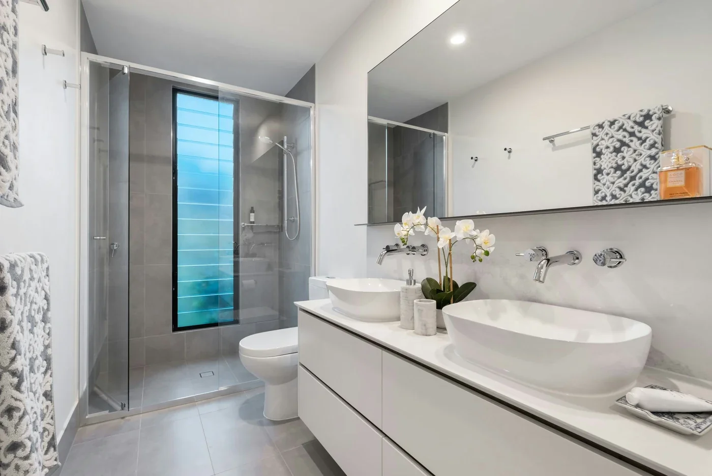 Bathroom renovation planning with coordinated fixture clearances, ventilation and tiled wet areas