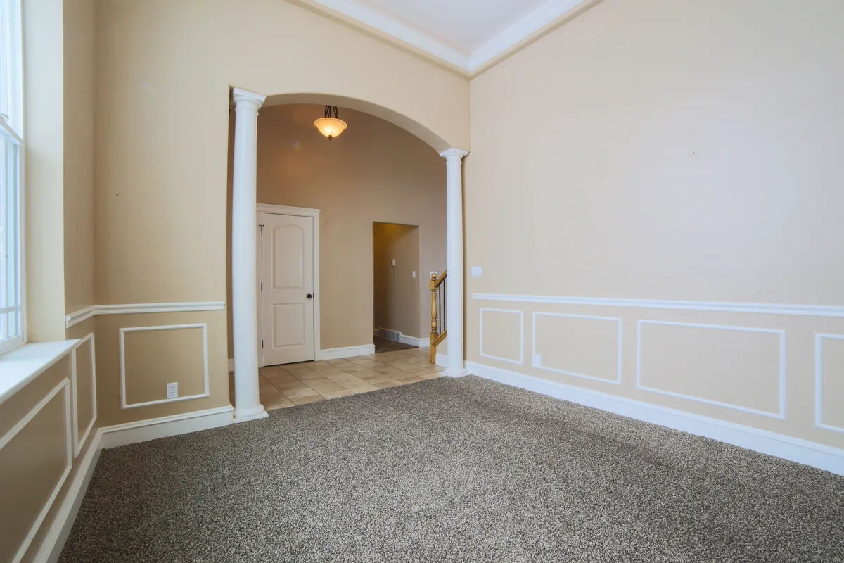 Restored plaster or drywall finish coordinated with original mouldings and trim